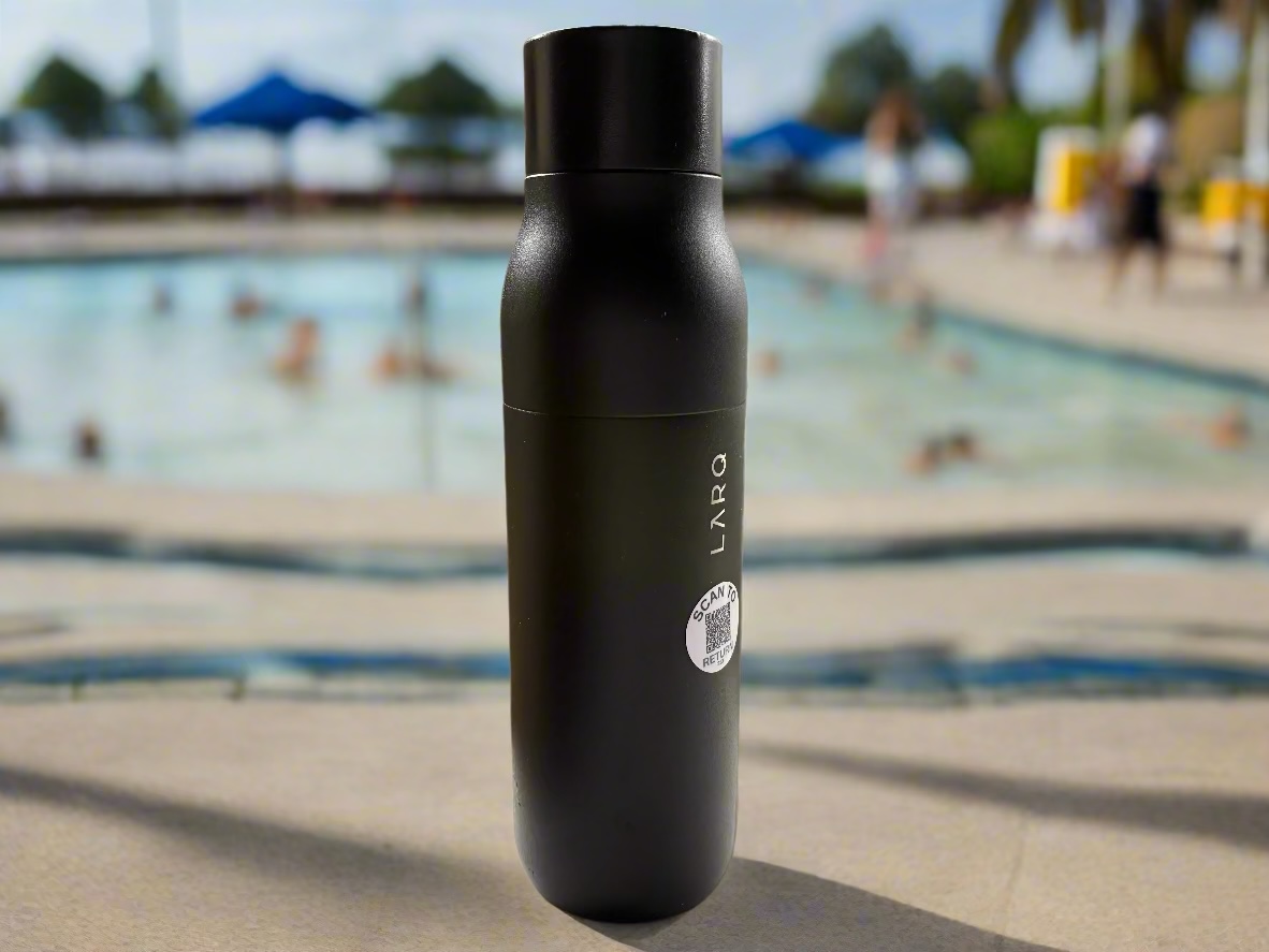 Water bottle with BeaconFound tag sitting by pool